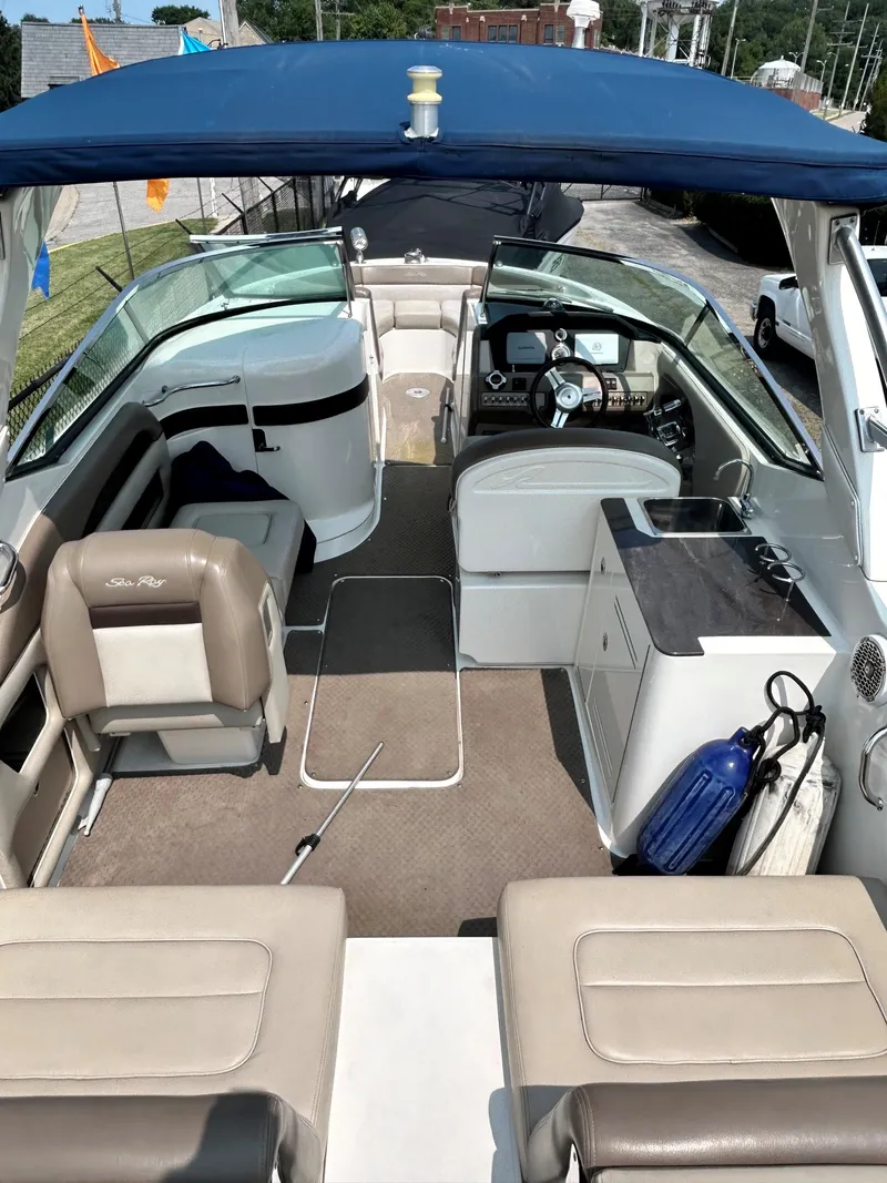 Slide: The Image of 2013 Sea Ray 300 SLX boat interior with seating, helm, and kitchenette. - 19