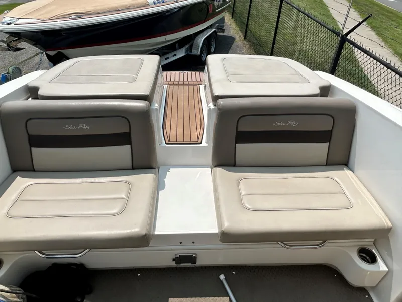 Slide: The Image of 2013 Sea Ray 300 SLX boat with beige seating and wooden deck. - 20