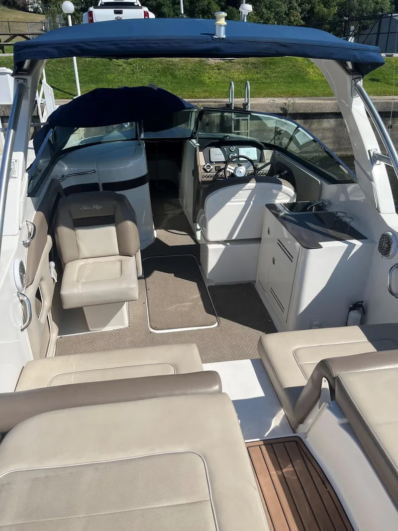 Slide: The Image of 2013 Sea Ray 300 SLX boat interior with seating and helm station. - 3