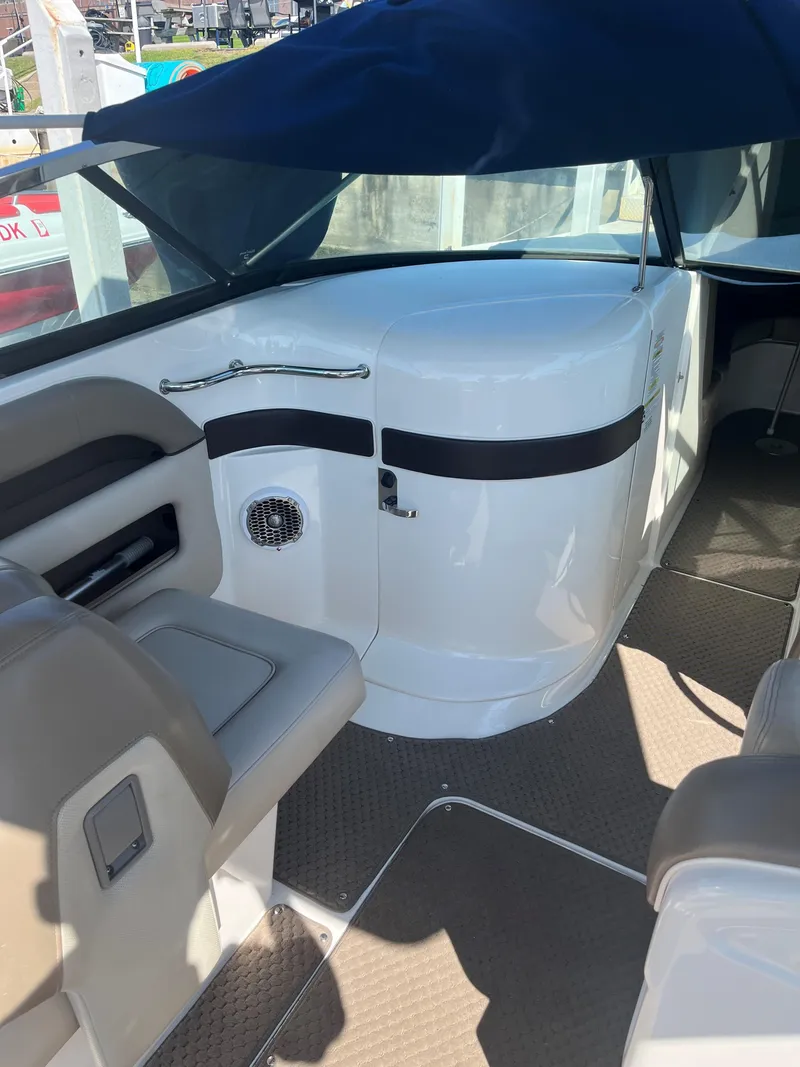 Slide: The Image of 2013 Sea Ray 300 SLX boat interior with seating and covered helm. - 7