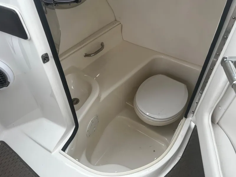 Slide: The Image of 2013 Sea Ray 300 SLX boat interior bathroom with toilet and sink. - 8