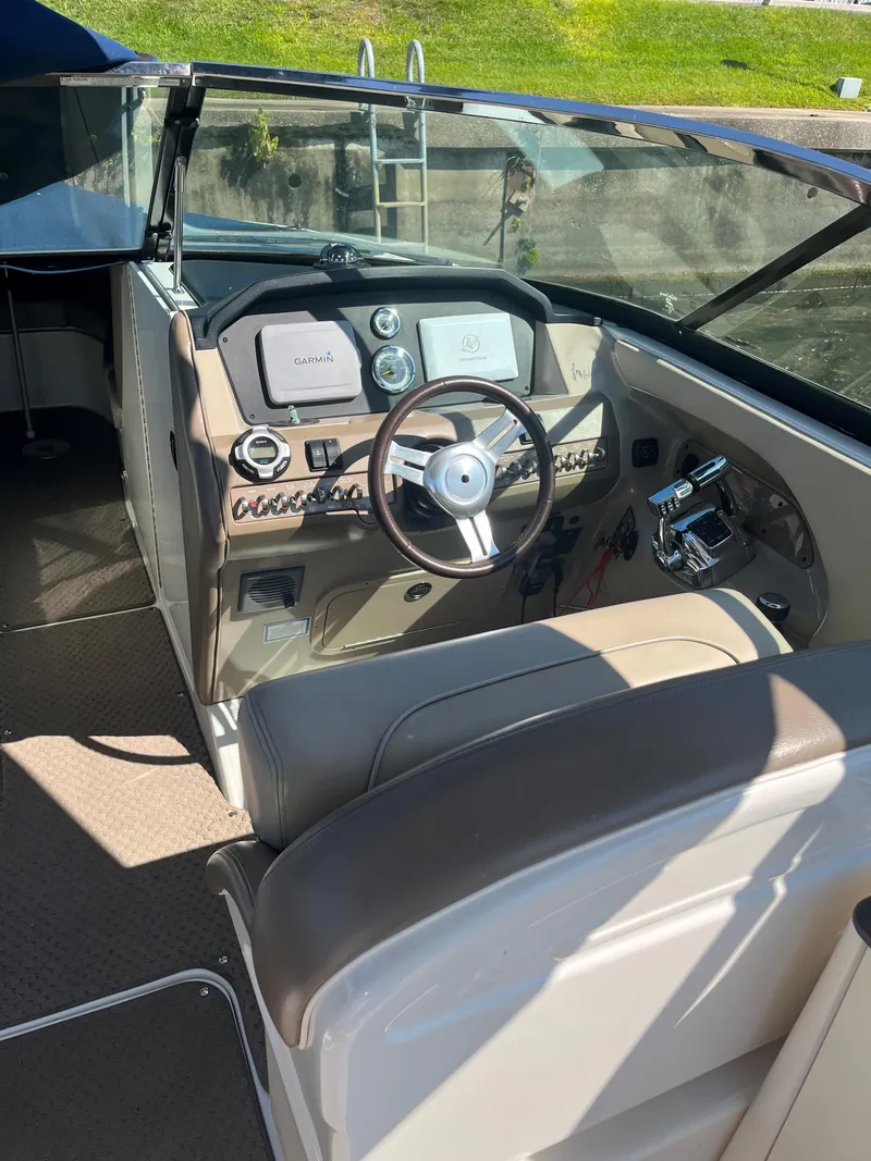 Slide: The Image of 2013 Sea Ray 300 SLX boat cockpit with steering wheel and control panel. - 9