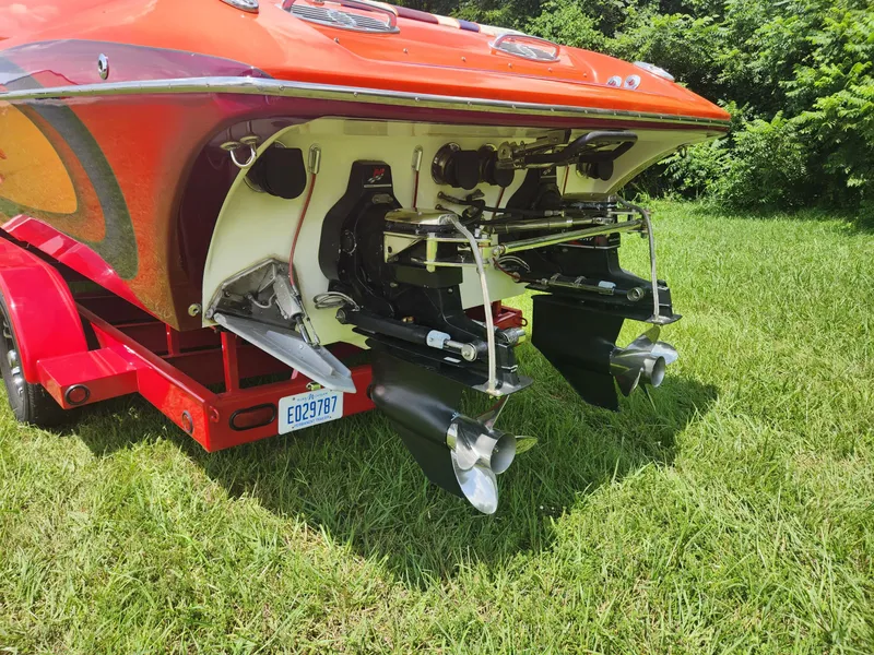 Slide: The Image of 2004 Eliminator 380 Eagle boat on red trailer, rear view showing dual propellers. - 10