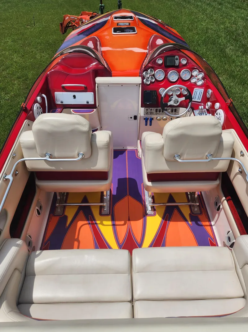 Slide: The Image of 2004 Eliminator 380 Eagle boat interior with vibrant orange and purple design. - 5