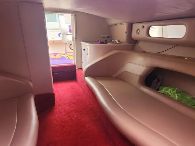 Slide: The Image of Interior cabin of a 2004 Eliminator 380 Eagle boat with red carpet and beige seating. - 6