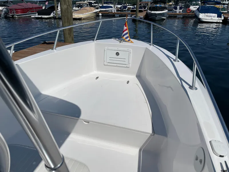 Slide: The Image of Angler 204CC 2002 boat docked with other boats in the background. - 11