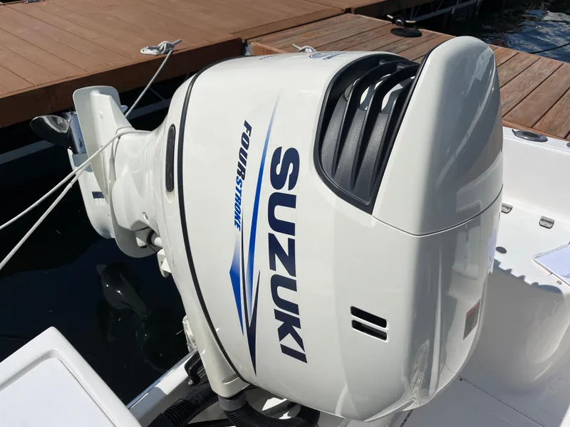 Slide: The Image of Suzuki outboard motor on a 2002 Angler 204CC boat. - 12