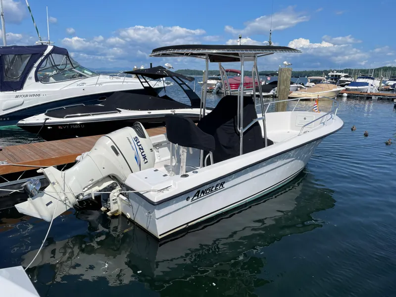 Slide: The Image of 2002 Angler 204CC boat docked at marina. - 2