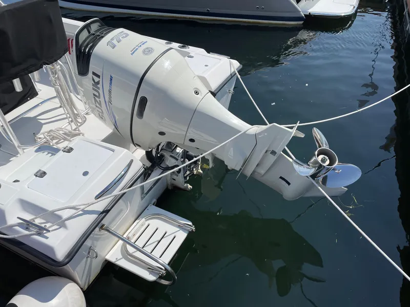 Slide: The Image of 2002 Angler 204CC boat with outboard motor in water. - 4
