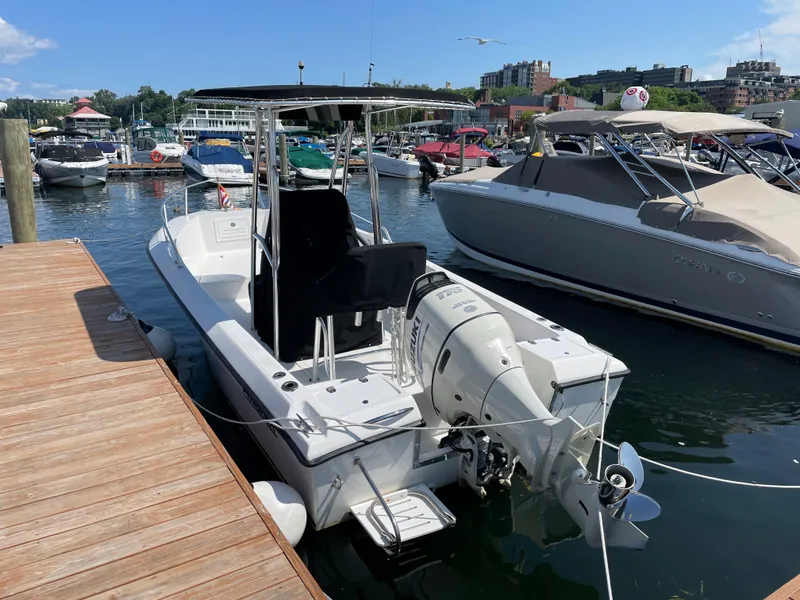 Slide: The Image of 2002 Angler 204CC boat docked at marina. - 5