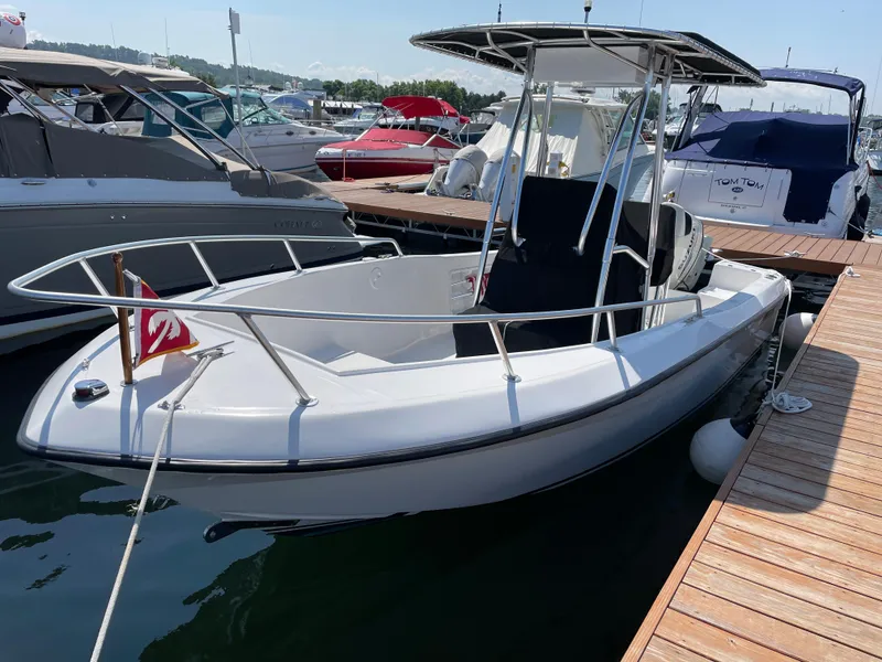 Slide: The Image of 2002 Angler 204CC boat docked at marina. - 6