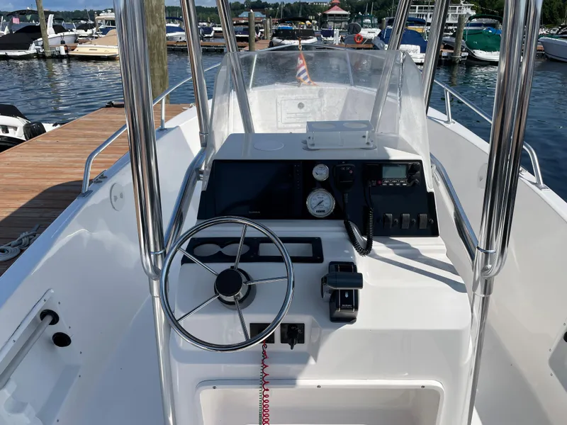 Slide: The Image of 2002 Angler 204CC boat console at the dock. - 7