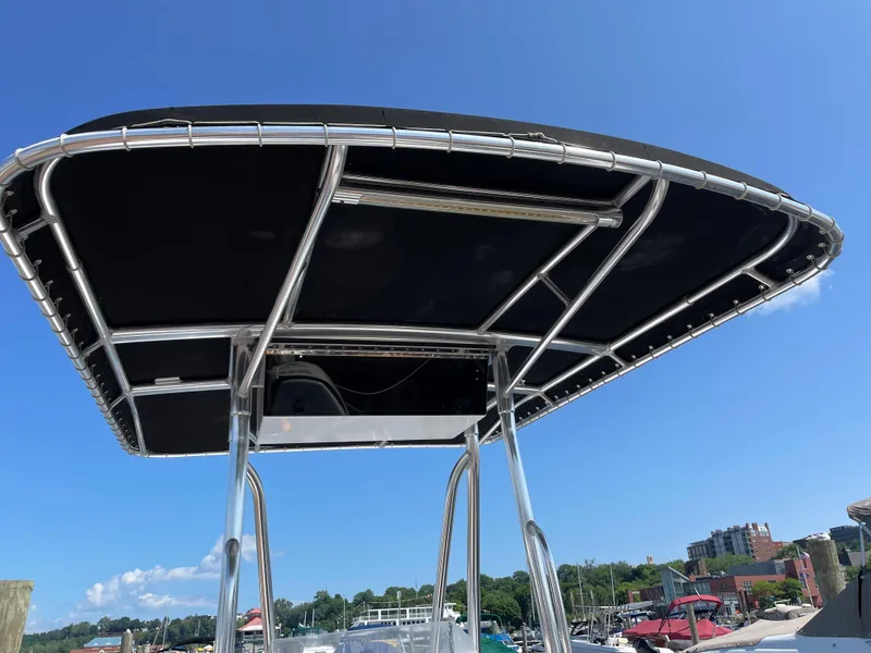 Slide: The Image of Angler 204CC 2002 boat with black canopy at the harbor. - 8