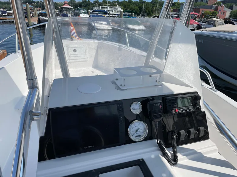 Slide: The Image of Console of a 2002 Angler 204CC boat at the marina. - 9
