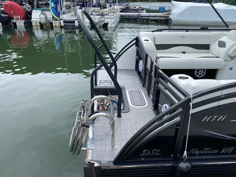 Slide: The Image of 2024 JC Neptoon Sport 23TT DSL pontoon boat docked at marina. - 25