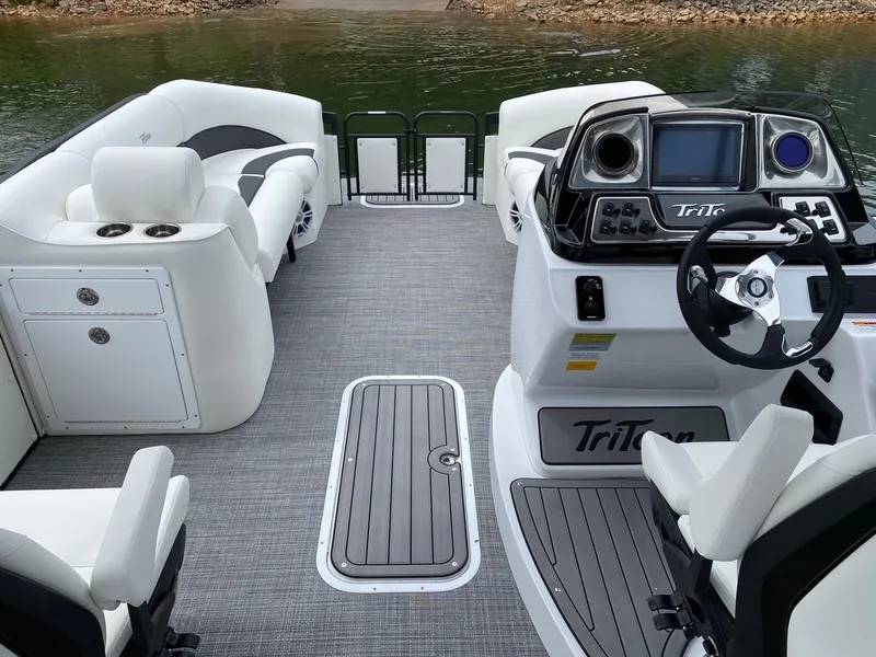 Slide: The Image of 2024 JC Neptoon Sport 23TT DSL pontoon boat interior with modern dashboard and seating. - 5