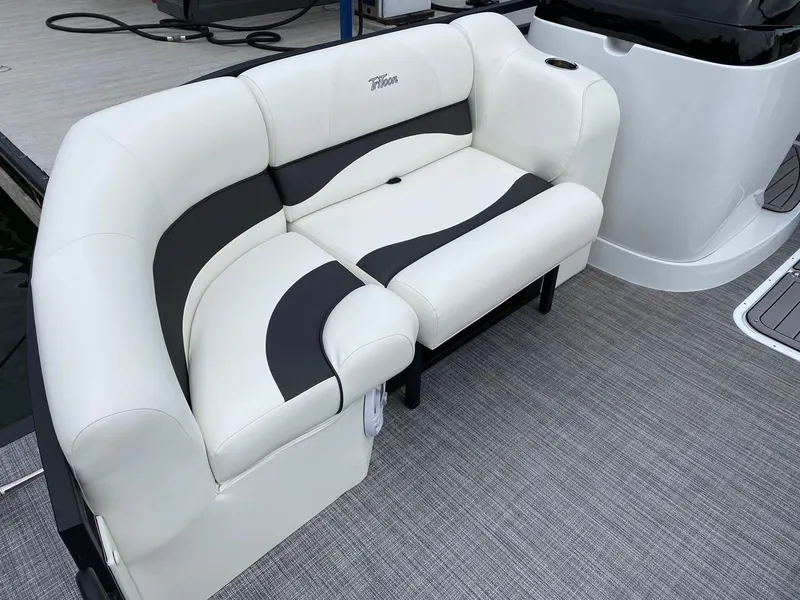 Slide: The Image of 2024 JC Neptoon Sport 23TT DSL boat with white and black cushioned seating. - 6