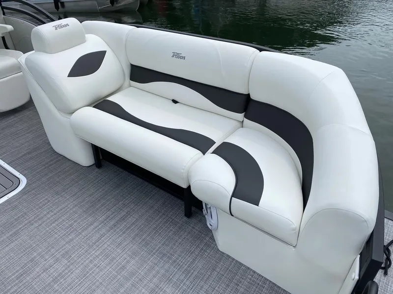 Slide: The Image of 2024 JC Neptoon Sport 23TT DSL boat with white and black cushioned seating. - 7