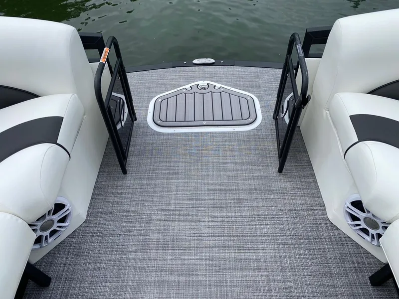 Slide: The Image of 2024 JC Neptoon Sport 23TT DSL boat interior with open gates and cushioned seating. - 8