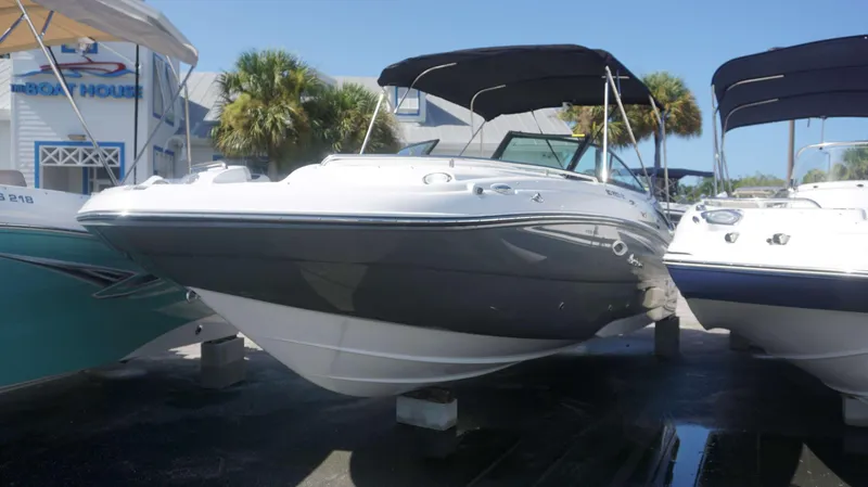 Slide: The Image of 2024 Hurricane 2200 SD boat displayed at a marina with palm trees. - 1