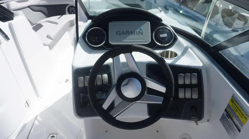 Slide: The Image of 2024 Hurricane 2200 SD boat dashboard with Garmin navigation system and steering wheel. - 14