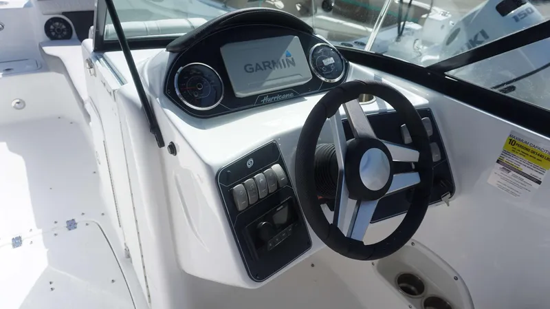 Slide: The Image of 2024 Hurricane 2200 SD boat dashboard with Garmin navigation system and steering wheel. - 15