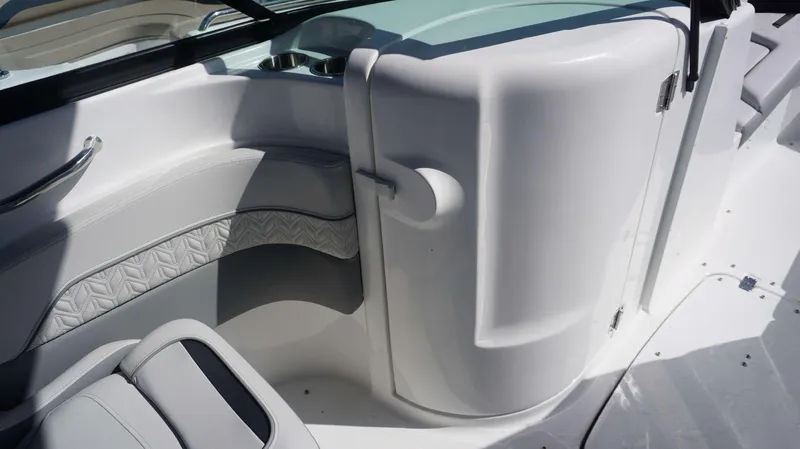 Slide: The Image of 2024 Hurricane 2200 SD boat interior with white seating and storage compartment. - 16