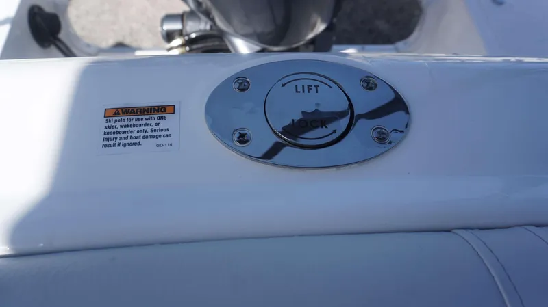 Slide: The Image of 2024 Hurricane 2200 SD boat ski pole lock mechanism with safety warning label. - 22