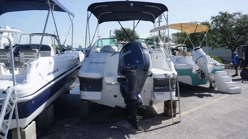 Slide: The Image of 2024 Hurricane 2200 SD boat with Yamaha engine, docked alongside other boats. - 3