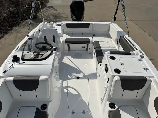 Slide: The Image of 2024 Tahoe 2150 boat interior with seating, steering console, and storage compartments. - 11