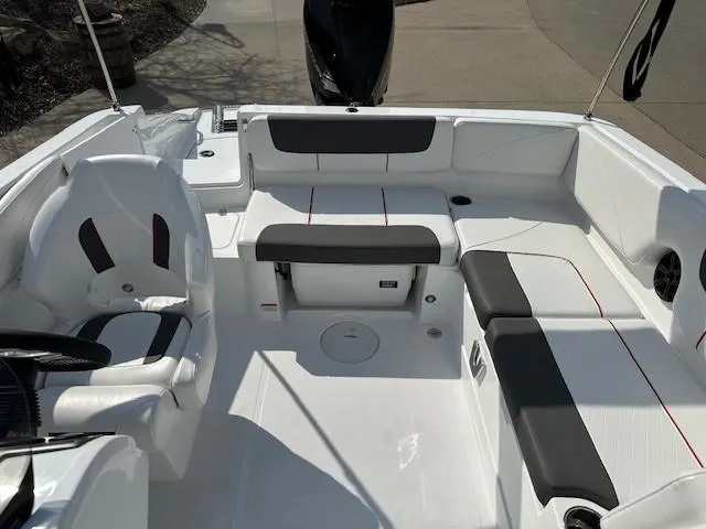 Slide: The Image of 2024 Tahoe 2150 boat interior with white and gray seating, modern design. - 12