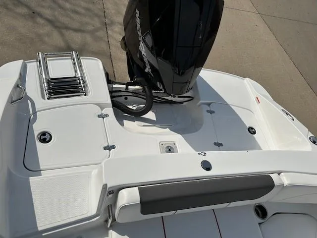 Slide: The Image of 2024 Tahoe 2150 boat deck with motor and swim ladder. - 14