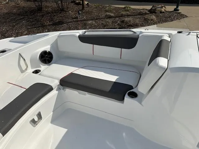 Slide: The Image of 2024 Tahoe 2150 boat interior with white and gray seating, cup holders, and speaker. - 4