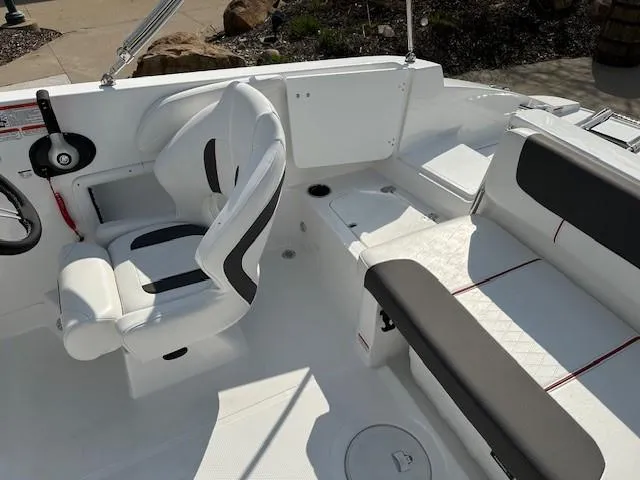 Slide: The Image of 2024 Tahoe 2150 boat interior with white seating and steering wheel. - 8