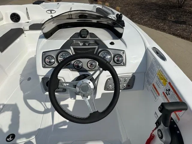 Slide: The Image of 2024 Tahoe 2150 boat dashboard with steering wheel and gauges. - 9