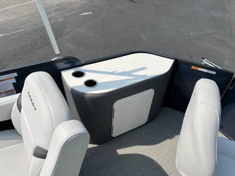 Slide: The Image of 2024 Crest Classic Fish 220 boat interior with seating and cup holders. - 10