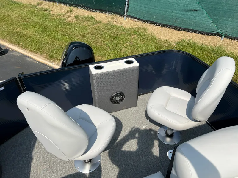 Slide: The Image of 2024 Crest Classic Fish 220 boat interior with two white seats and cup holders. - 11