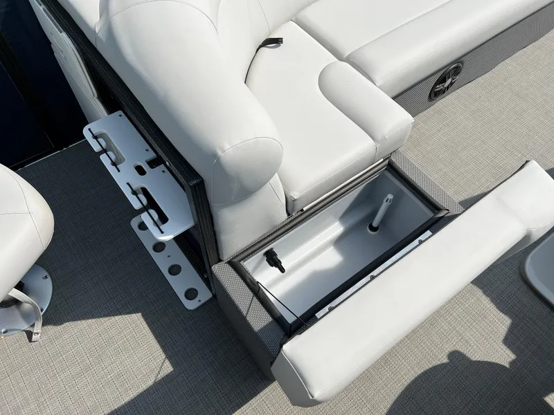 Slide: The Image of 2024 Crest Classic Fish 220 boat interior with open storage compartment and seating. - 13