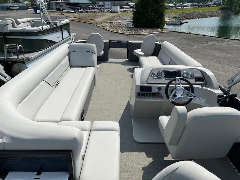 Slide: The Image of 2024 Crest Classic Fish 220 pontoon boat with spacious seating and modern dashboard. - 16