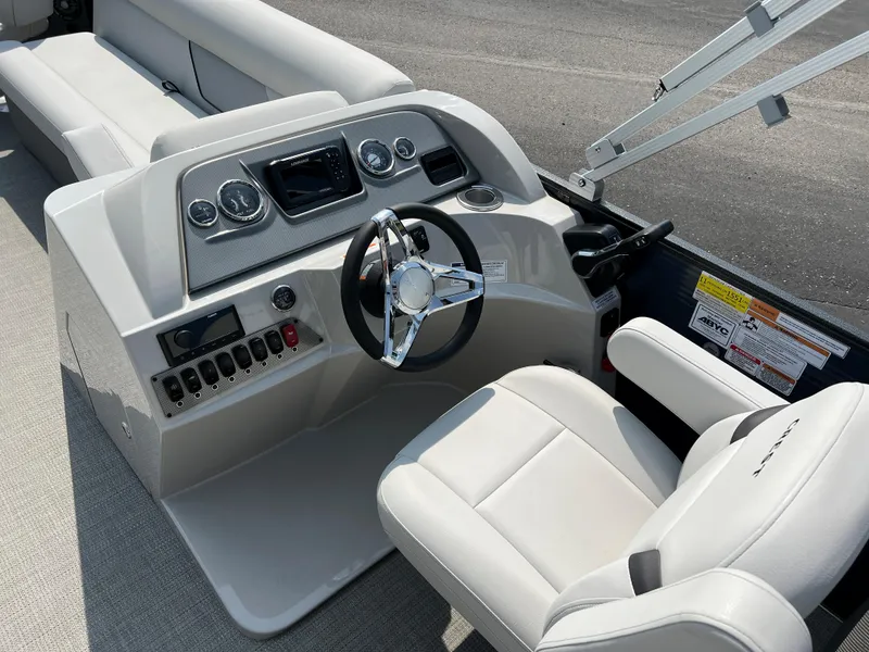 Slide: The Image of 2024 Crest Classic Fish 220 boat interior with modern dashboard and comfortable seating. - 17