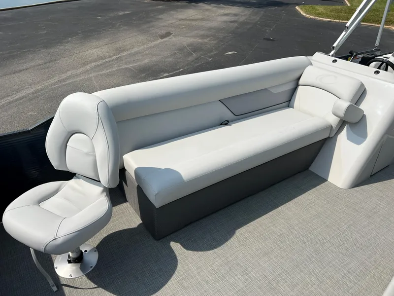 Slide: The Image of 2024 Crest Classic Fish 220 boat interior with white seating and gray flooring. - 7