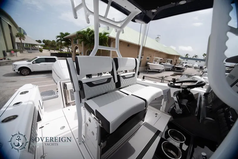 Slide: The Image of 2024 Blackfin 272 CC boat interior with seating and steering wheel, displayed at Sovereign Yachts. - 18