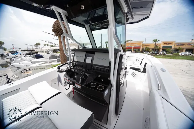 Slide: The Image of 2024 Blackfin 272 CC boat interior with modern dashboard and seating. - 19