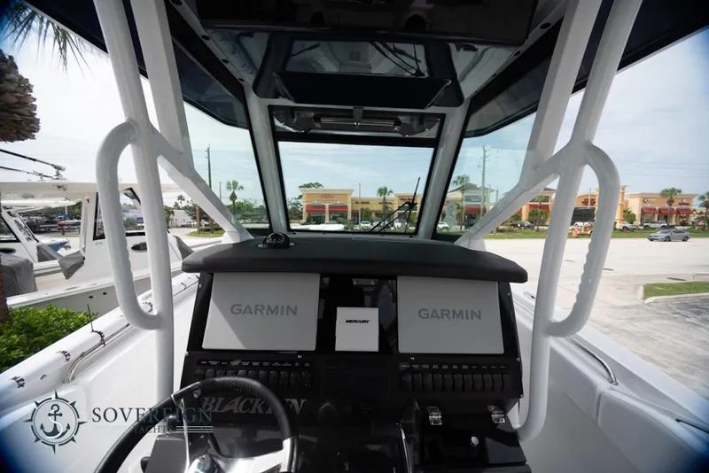 Slide: The Image of 2024 Blackfin 272 CC boat dashboard with Garmin navigation displays. - 20