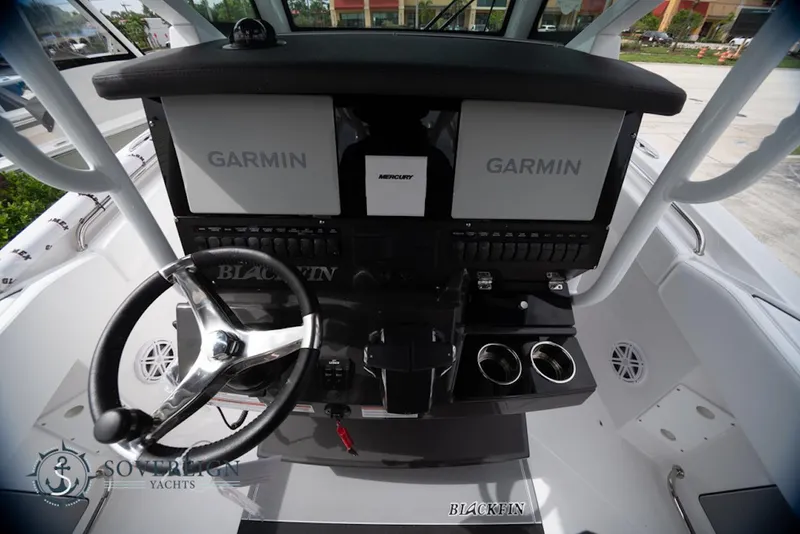 Slide: The Image of 2024 Blackfin 272 CC boat helm with Garmin displays and steering wheel. - 21