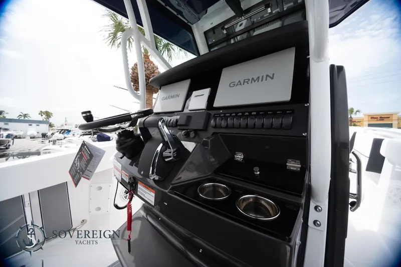 Slide: The Image of 2024 Blackfin 272 CC boat console with Garmin navigation systems and controls. - 22