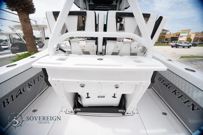 Slide: The Image of 2024 Blackfin 272 CC boat interior with seating and storage, Sovereign Yachts branding. - 28