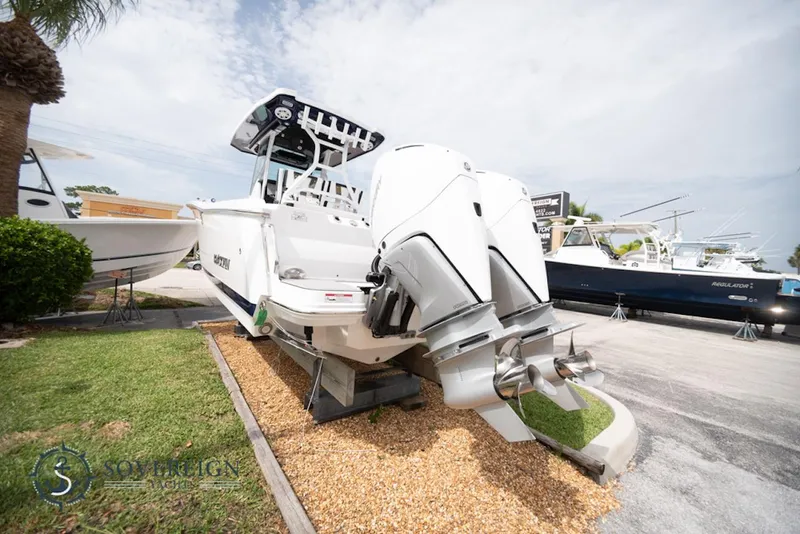 Slide: The Image of 2024 Blackfin 272 CC boat with dual outboard engines displayed outdoors. - 4