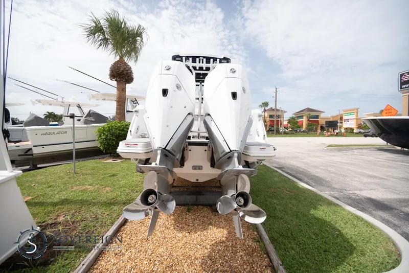Slide: The Image of 2024 Blackfin 272 CC boat with dual outboard engines, displayed outdoors. - 5