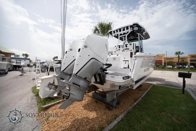 Slide: The Image of 2024 Blackfin 272 CC boat with dual engines displayed outdoors. - 6